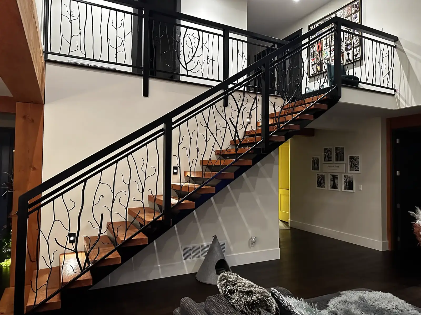 Branch railing following the stair up to the landing