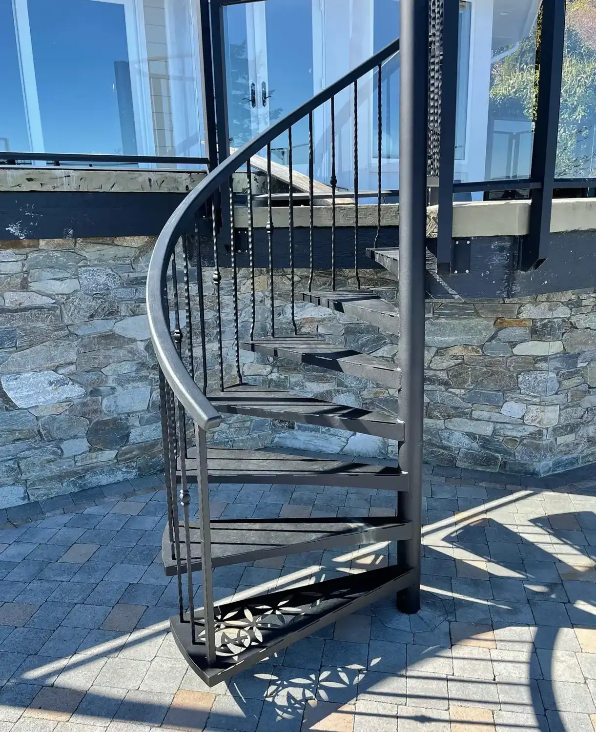 The spiral stair and its shadow on the patio