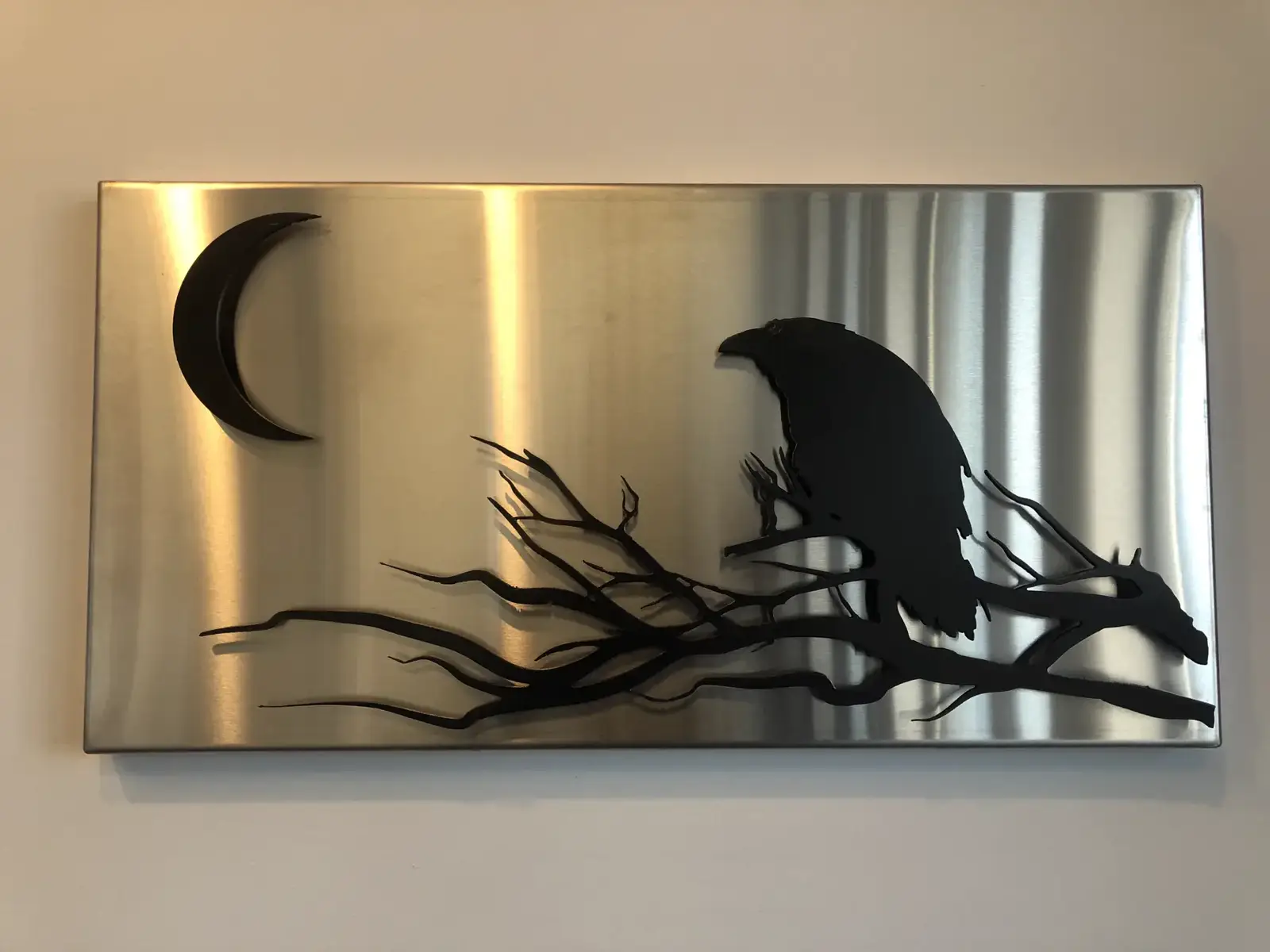 Raven and moon on brushed stainless